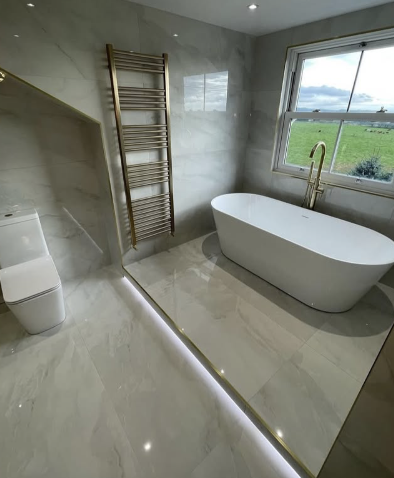 Marble bathroom with brushed gold tapware